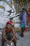 Residents of Brazilian artist Bel Borba’s hometown, Salvador de Bahia, with his artwork, as seen in BEL BORBA AQUI, directed by Burt Sun and Andr&eacute; Costantini, with his work. Courtesy of Abramorama.