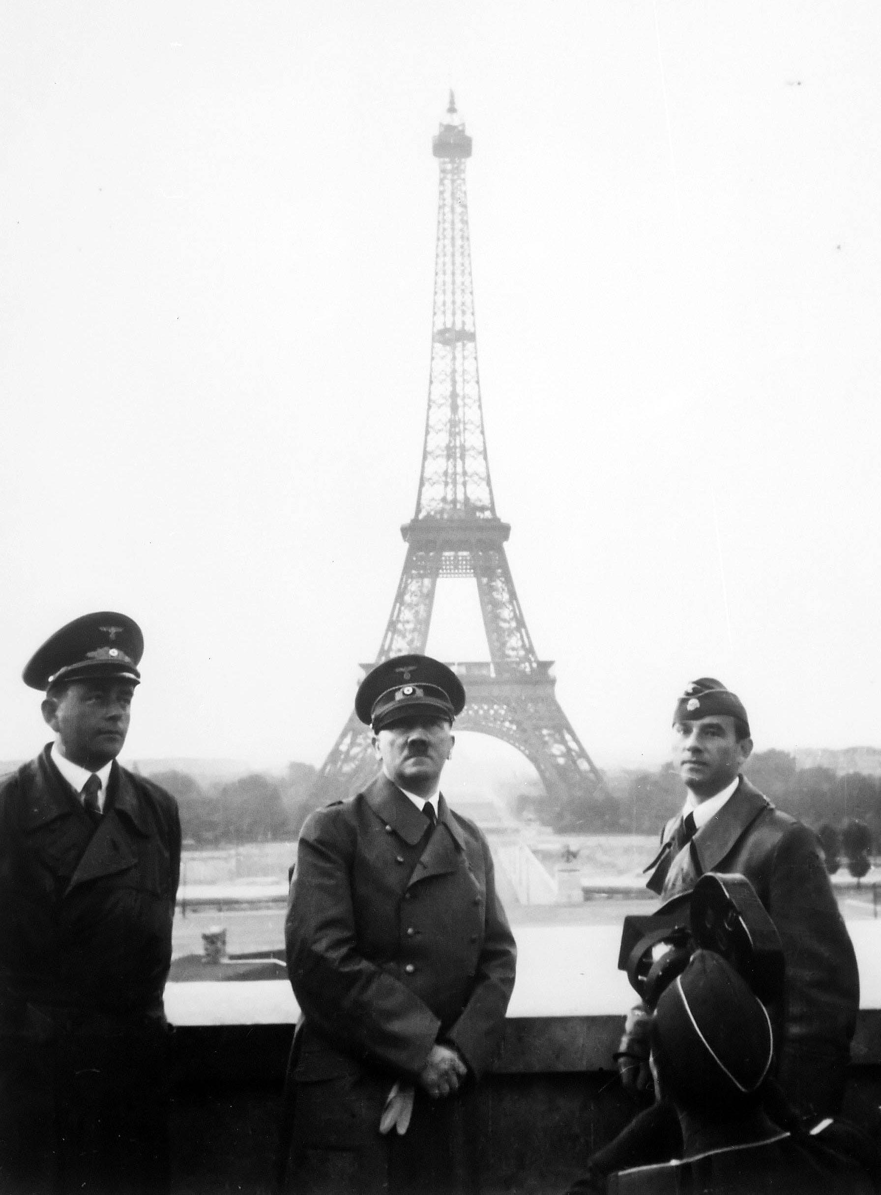 Adolf Hitler touring Paris, France, on June 23, 1940. The Eiffel Tower is visible in the background.  The day before (June 22), France signed an armistice with Germany following the Germans' successful invasion.
