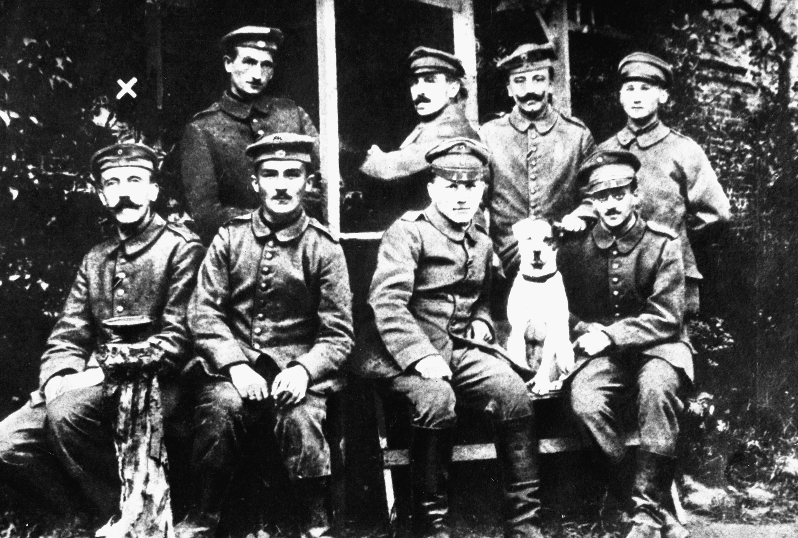 Adolf Hitler as a young soldier during World War I. Hitler was a decorated veteran of the war. He is on the left of the photograph, identified with an X placed above his head.