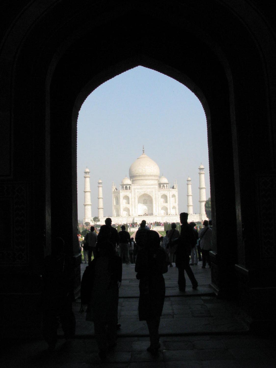 The Taj Mahal, framed by the gateway entrance. The Taj Mahal, one of the world's most popular tourist destinations, is located in Agra, India.