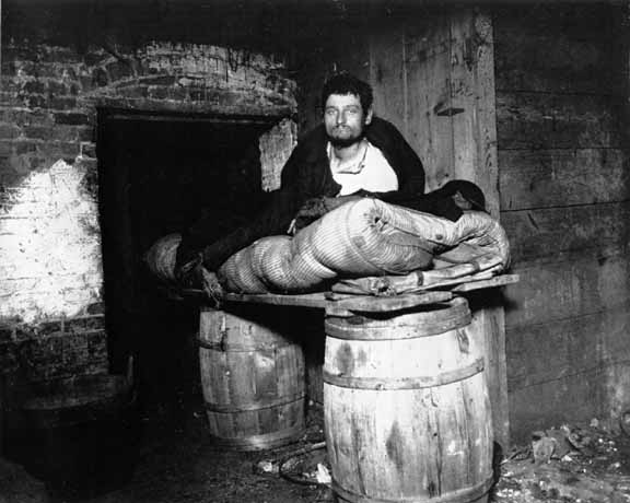 A Cave Dweller in New York City, photographed by Jacob Riis in 1890.