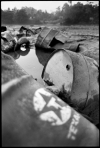 Caption: Old Texaco barrels left on the banks of the Aguarico River near Lago Agrio.