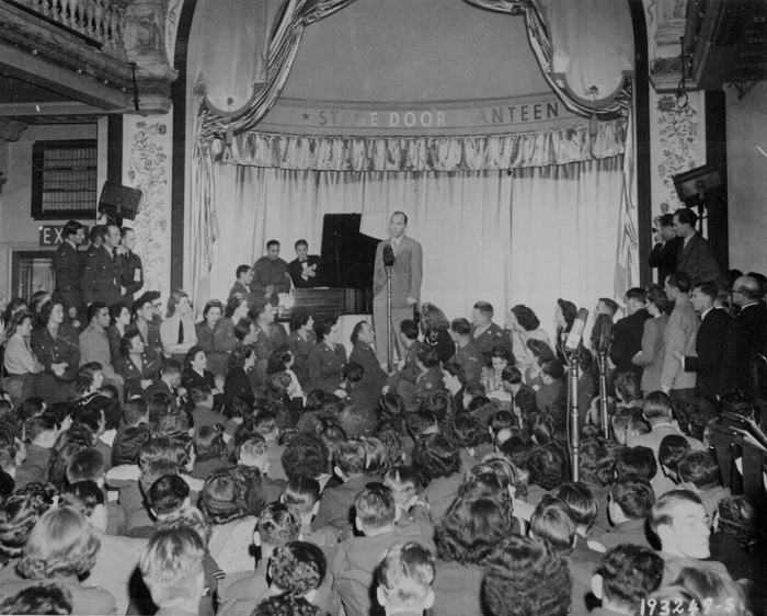 Bing Crosby, stage, screen and radio star, sings to Allied troops at the opening of the London stage door canteen in Piccadilly, London, England.