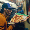 Eating pizza on the subway