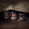 Scared kids hiding under the bed