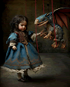 Little girl with a dragon marionette