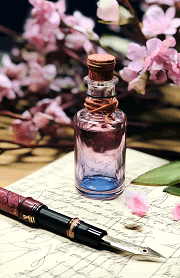 pink, purple, and violet glass bottle of fountain pen ink
